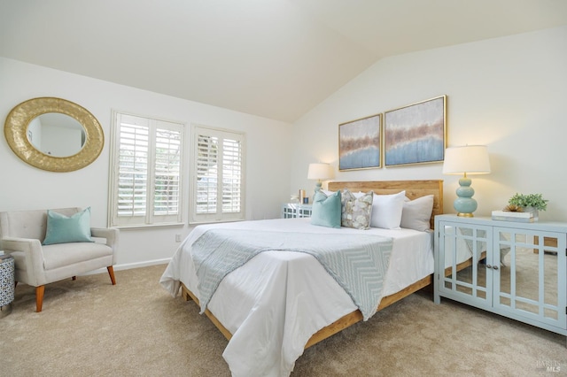 carpeted bedroom featuring lofted ceiling