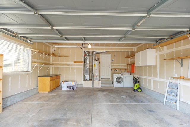 garage with washer and clothes dryer and gas water heater