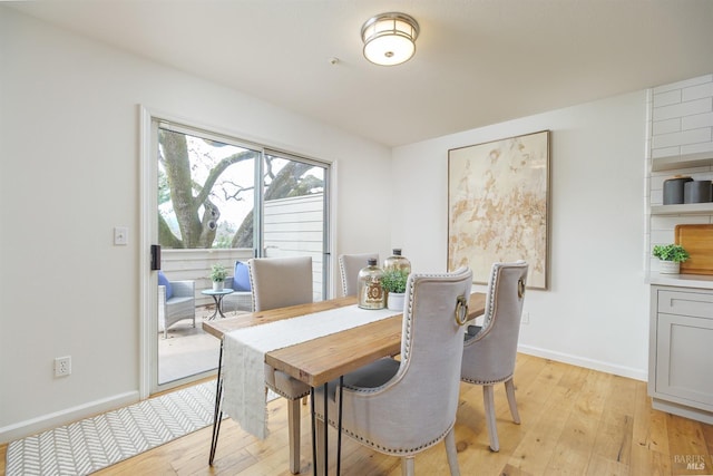 dining space featuring light wood-type flooring