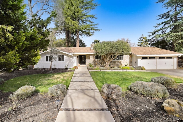 ranch-style house with an attached garage, a chimney, a front lawn, stone siding, and aphalt driveway