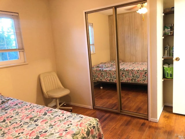 bedroom featuring hardwood / wood-style floors and a closet