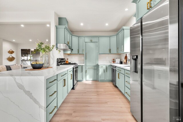 kitchen with under cabinet range hood, appliances with stainless steel finishes, light wood-style floors, and recessed lighting