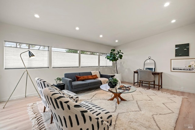 living room featuring light wood-type flooring, baseboards, and recessed lighting