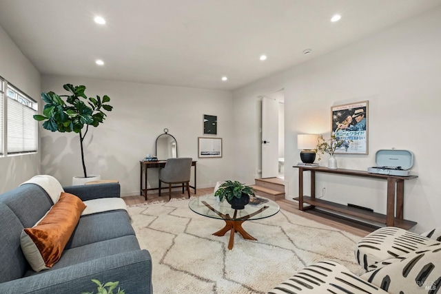 living room featuring recessed lighting, baseboards, and light wood finished floors