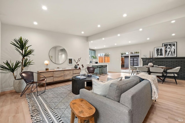 living room with baseboards, light wood-type flooring, and recessed lighting