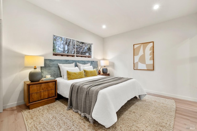 bedroom with light wood-style flooring, baseboards, vaulted ceiling, and recessed lighting