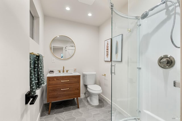 full bathroom featuring recessed lighting, toilet, a shower stall, vanity, and tile patterned flooring