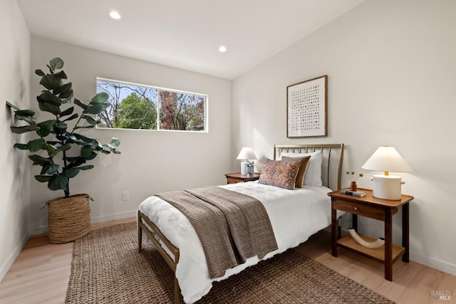 bedroom with recessed lighting, light wood-style flooring, and baseboards