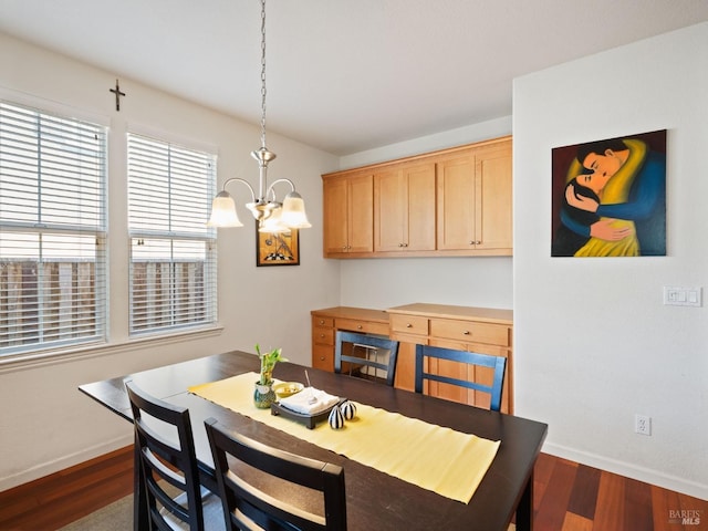 dining area with an inviting chandelier, dark wood finished floors, and baseboards