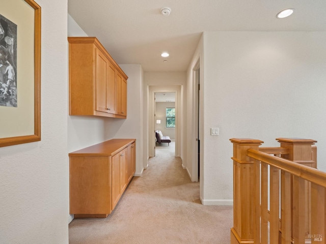 corridor with light carpet, recessed lighting, and baseboards