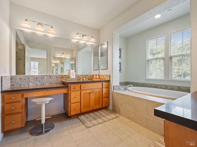 bathroom featuring tasteful backsplash, a garden tub, vanity, and tile patterned floors