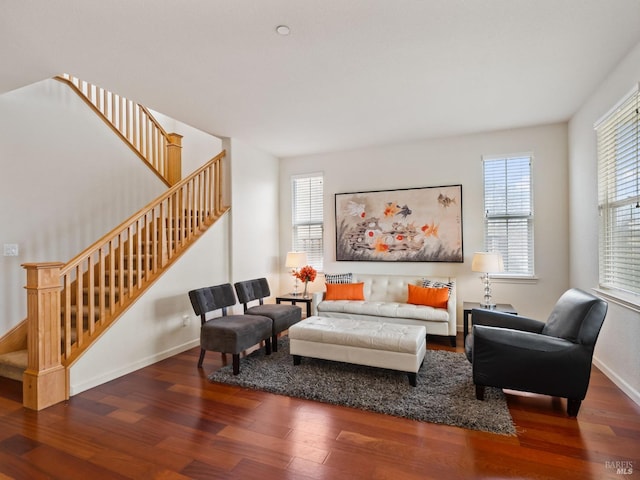 living room with baseboards, stairs, and wood finished floors