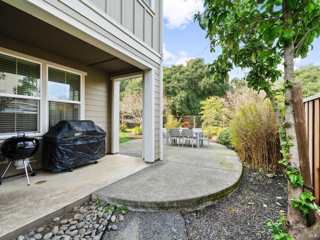 view of patio / terrace with outdoor dining area, a grill, and fence