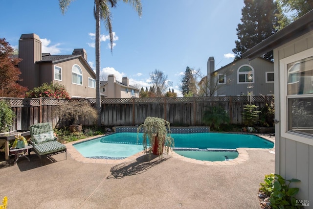 view of swimming pool with a patio area and a fenced backyard