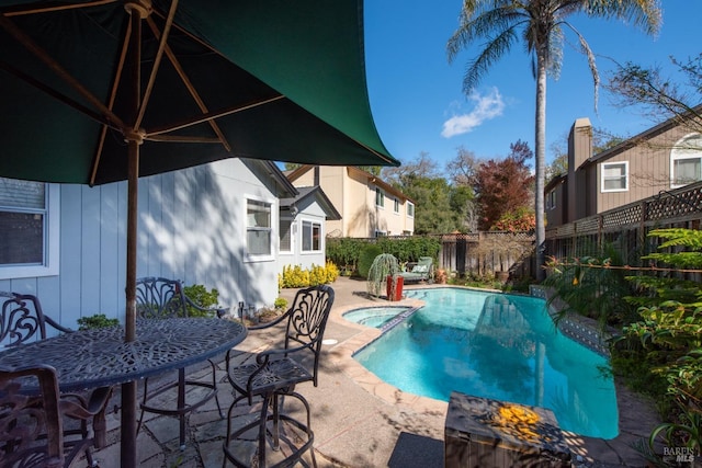 view of swimming pool with a patio area, a fenced backyard, and a pool with connected hot tub