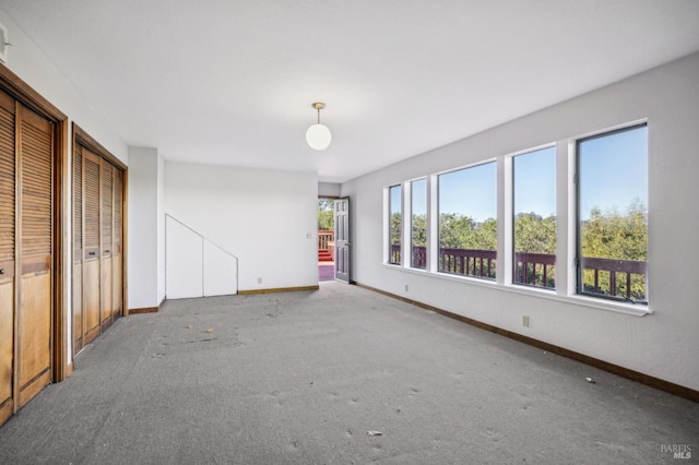 interior space with carpet and baseboards