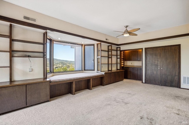 interior space with visible vents, a mountain view, and light colored carpet