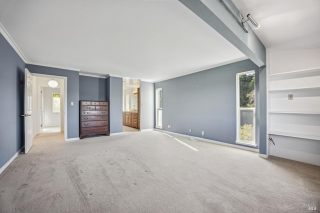 unfurnished bedroom featuring light carpet, baseboards, and crown molding