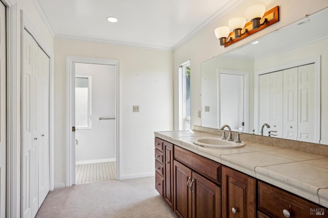 bathroom with ornamental molding, a closet, carpet floors, and vanity