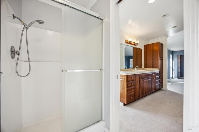 bathroom with ornamental molding, a shower with door, and vanity