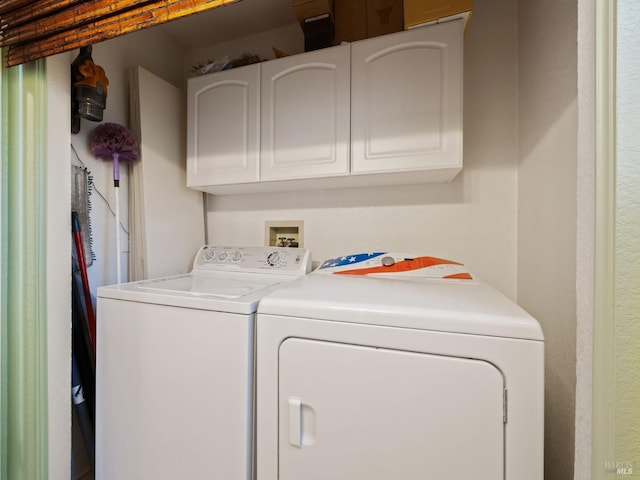 laundry room featuring cabinet space and washer and clothes dryer