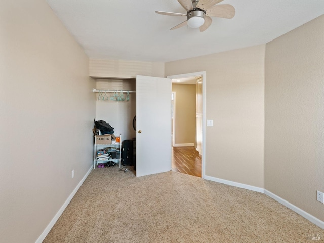 bedroom with a closet, light colored carpet, and baseboards