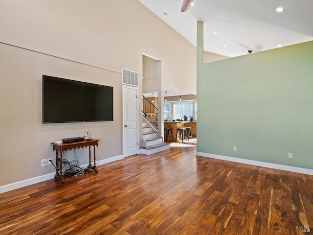 unfurnished living room featuring visible vents, dark wood finished floors, stairway, and baseboards