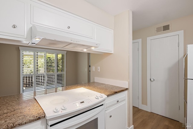 kitchen with light hardwood / wood-style flooring, white appliances, dark stone counters, custom exhaust hood, and white cabinets