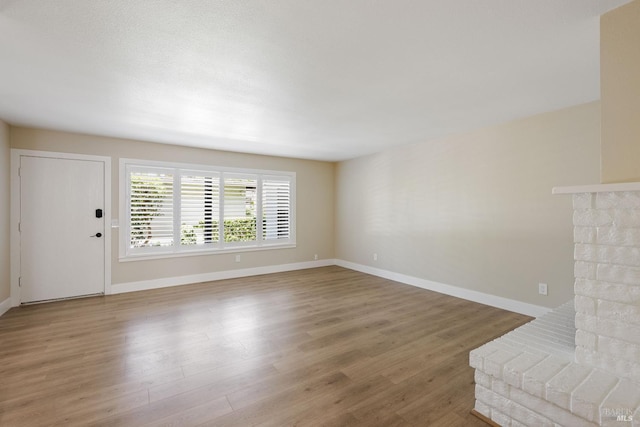 unfurnished living room featuring hardwood / wood-style flooring