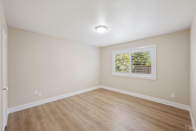 unfurnished room with light wood-type flooring