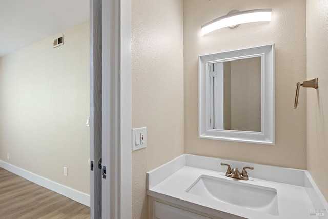 bathroom featuring hardwood / wood-style flooring and vanity