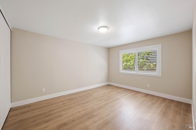 spare room featuring light hardwood / wood-style flooring