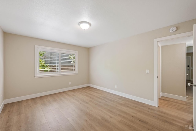 unfurnished room with light hardwood / wood-style flooring