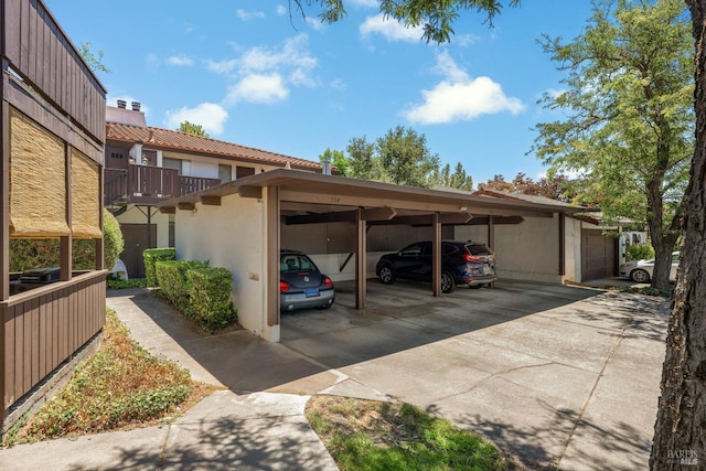 view of parking / parking lot featuring a carport