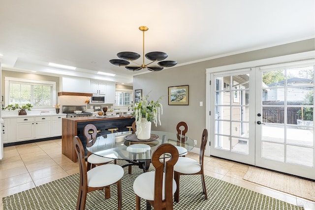 dining room with ornamental molding, french doors, and light tile patterned floors