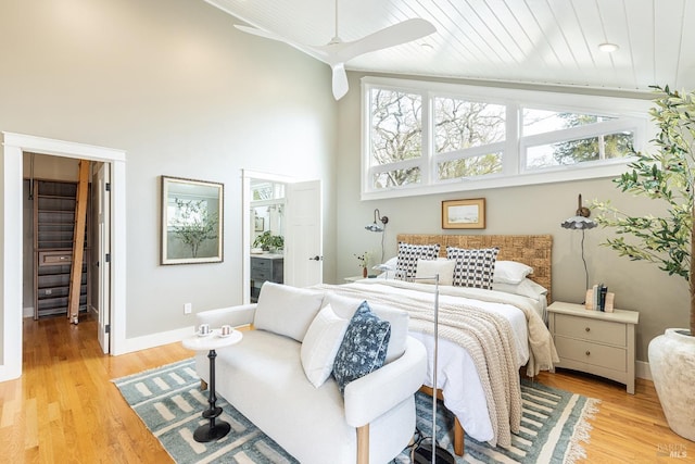 bedroom featuring high vaulted ceiling, light wood-type flooring, and wood ceiling