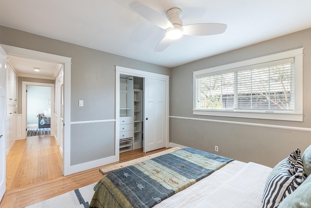 bedroom with a closet, hardwood / wood-style floors, and ceiling fan