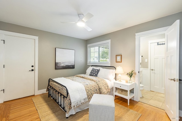 bedroom with light wood-type flooring, ensuite bath, and ceiling fan