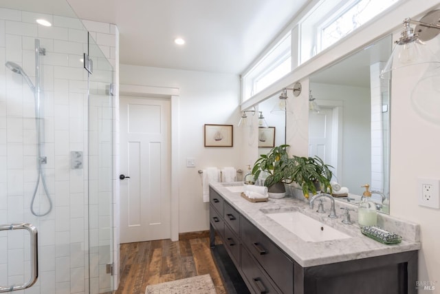 bathroom with vanity, an enclosed shower, and wood-type flooring