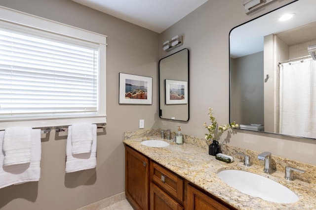 bathroom featuring toilet, tile patterned floors, and vanity