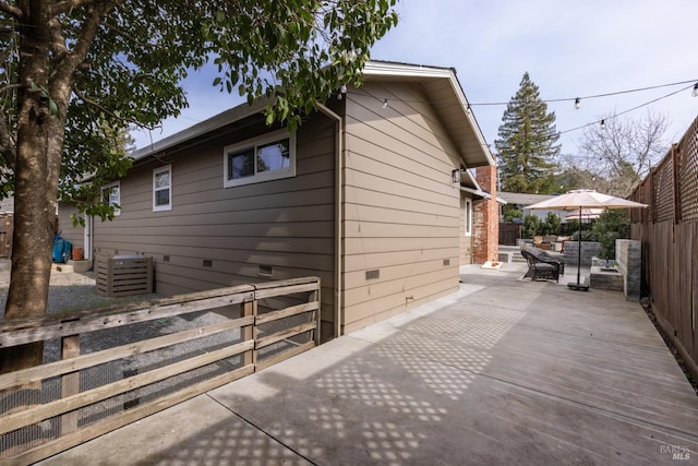 view of side of home with a patio area