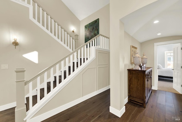 stairway with recessed lighting, lofted ceiling, baseboards, and wood finished floors