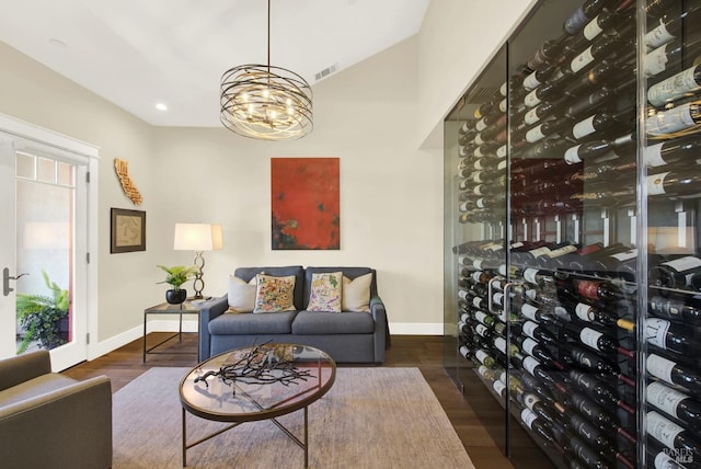 wine room with a notable chandelier, recessed lighting, visible vents, dark wood-type flooring, and baseboards