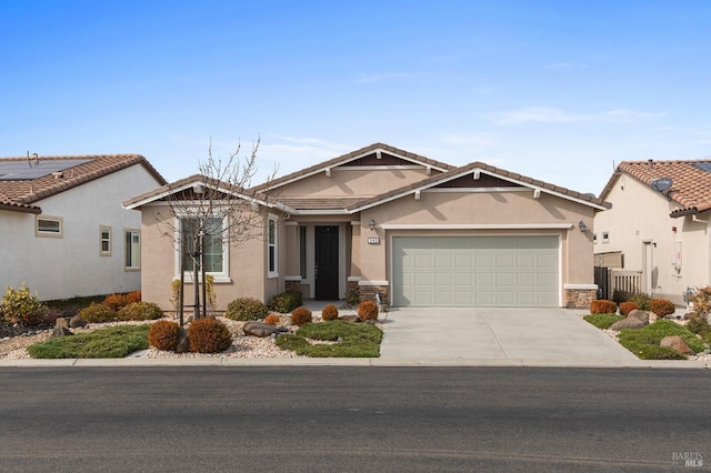 view of front of house with a garage, concrete driveway, fence, and stucco siding