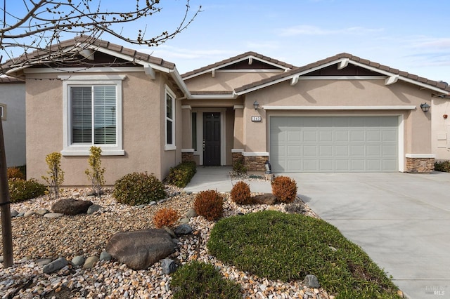 view of front of house with a garage, stone siding, concrete driveway, and stucco siding