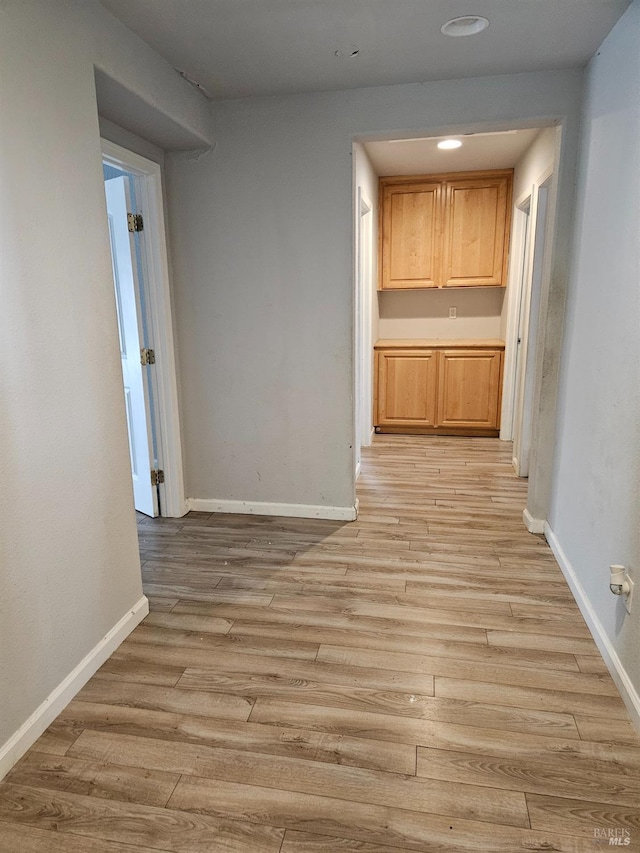 interior space featuring light wood-style floors and baseboards