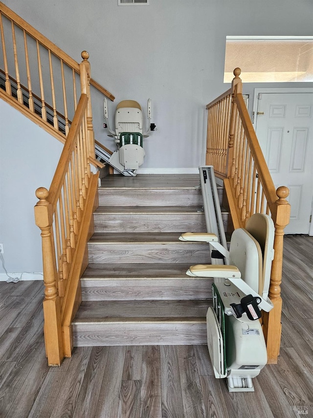 stairs featuring wood finished floors