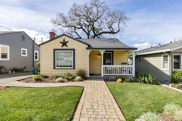 bungalow with a front lawn and a porch