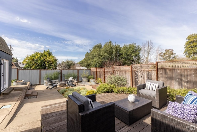 wooden deck featuring a fenced backyard, an outdoor hangout area, and a patio