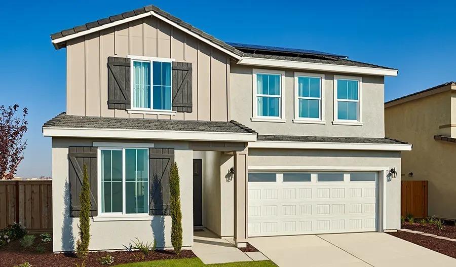 view of front facade with a garage and solar panels